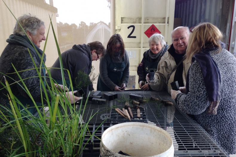 Members of the volunteer group getting their hands dirty weeding and potting in our Canberra Nursery.