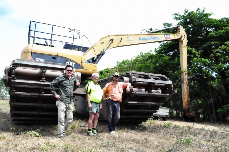 Civil Plus Construction’s amphibious excavator with Niall Connolly (left), Neil Griggs (centre) and Tony Compton (right).