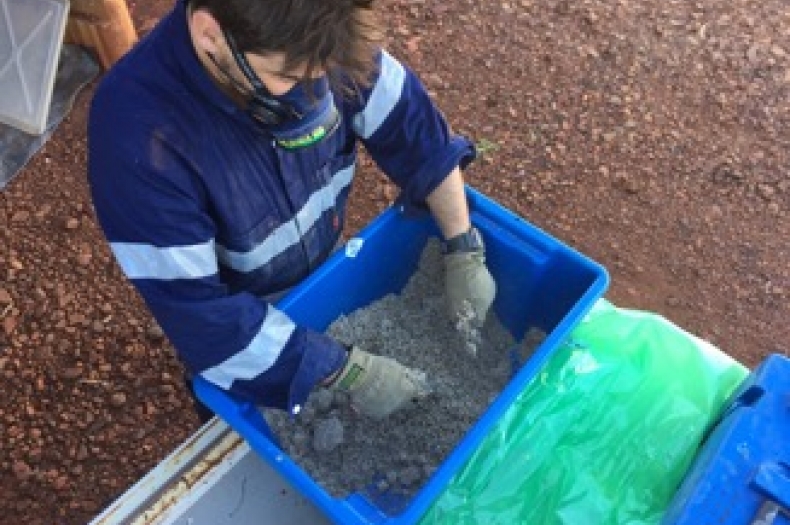 Senior Technician Liam Mulcahy mixing the fine native seed mix for the restoration project.