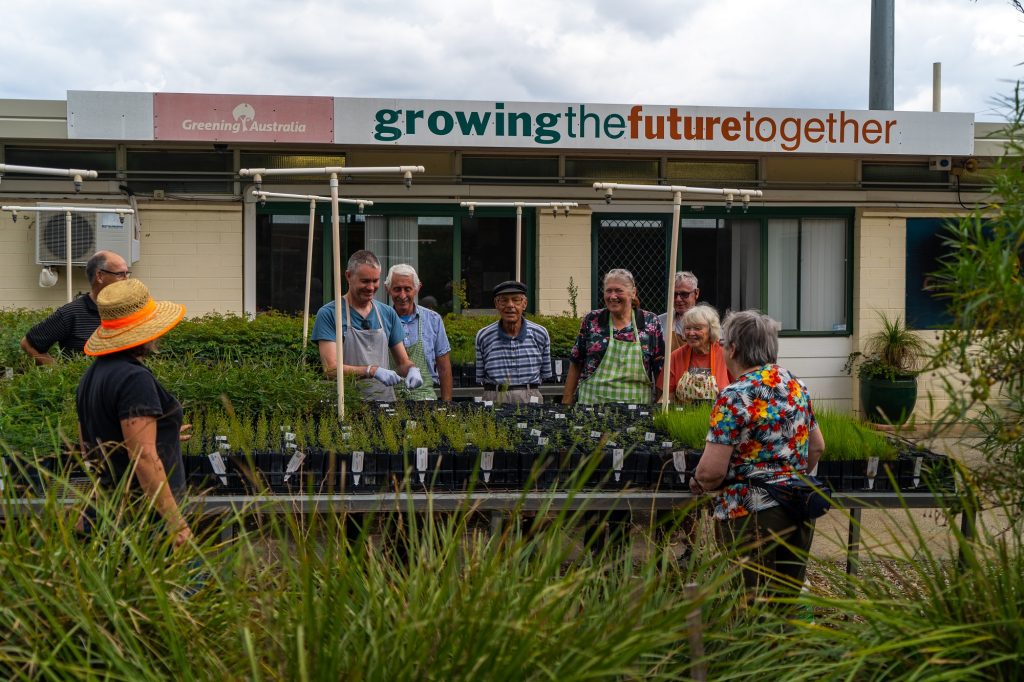 men and women volunteering in seed nursery