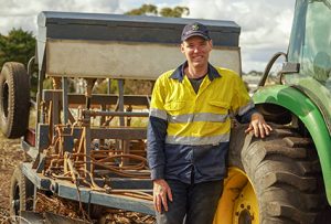 GA staff member stands by tractor