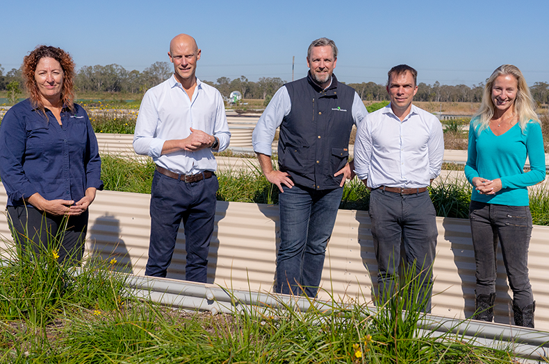 A photo showing representatives from both Greening Australia and CBA, standing in a seed production area