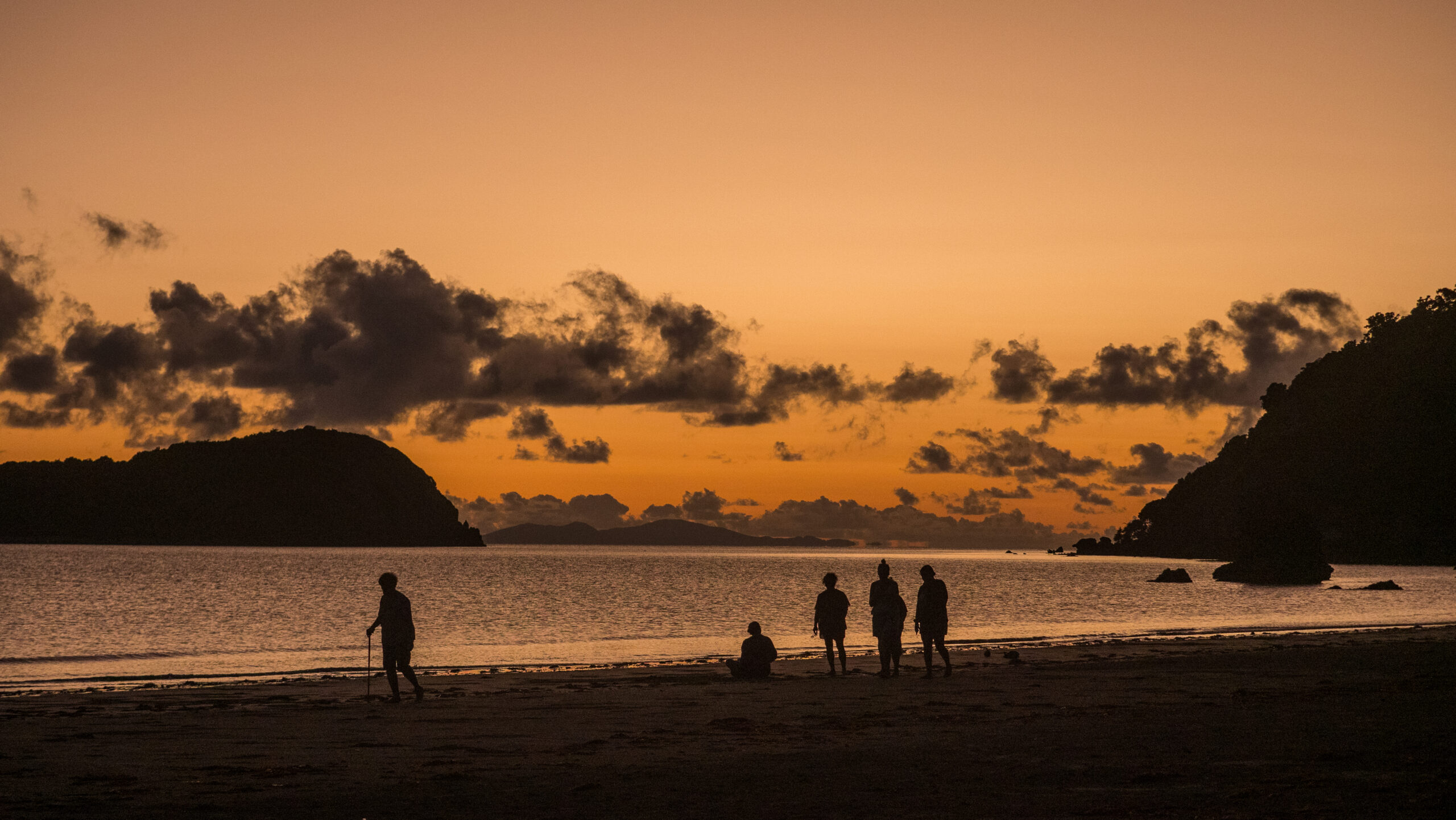 People silhouetted in the early dawn light.