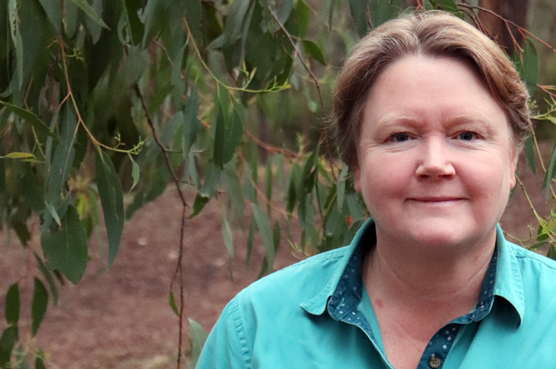 A photo of Heather Campbell standing under a gum tree.